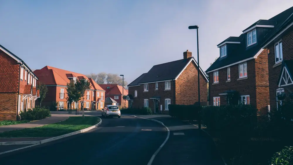 English suburban street of red-brick houses with pitched tiled roofs