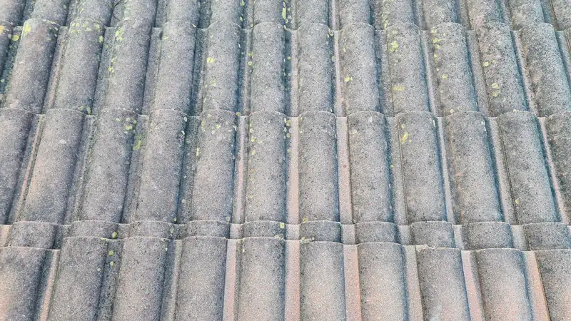 Close-up of textured concrete roof tiles showing profile and surface pattern