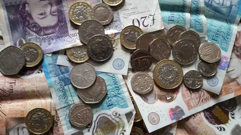 British pound coins and banknotes representing a roofing cost estimate