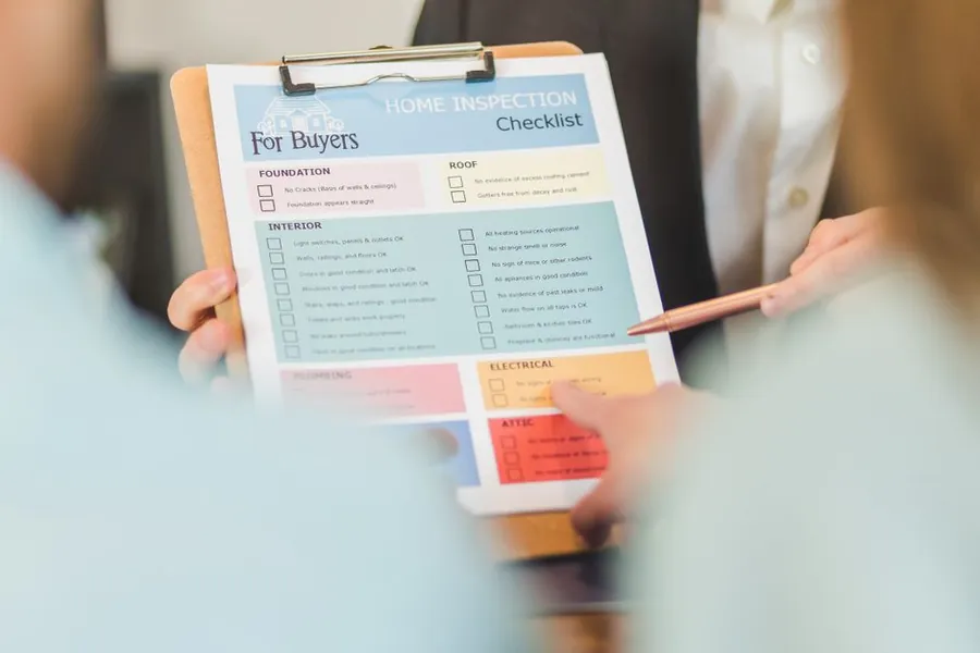 Printed home inspection checklist with the roof section being checked off