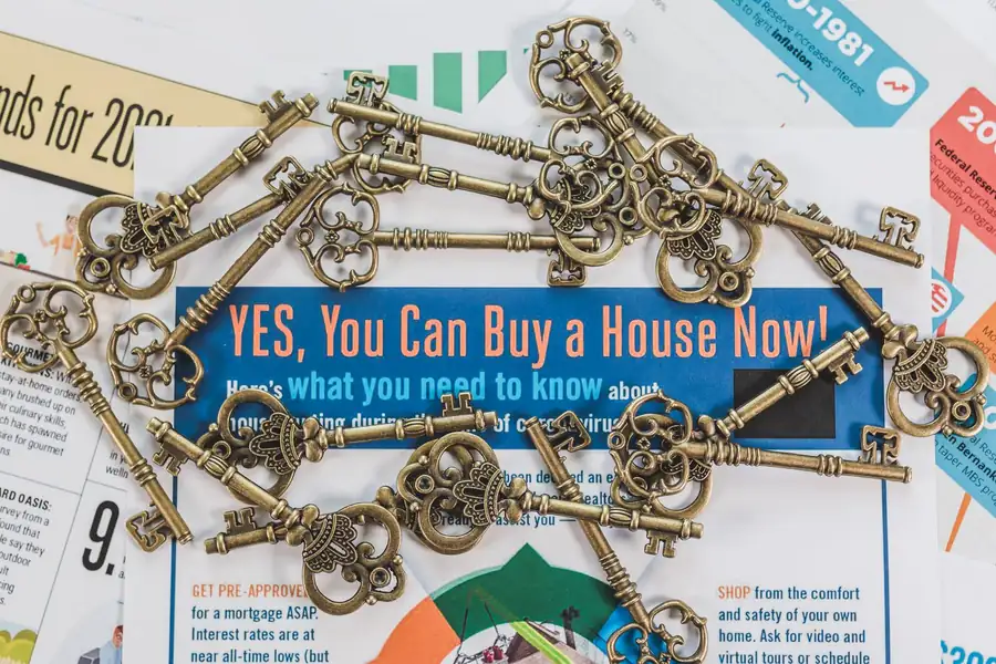 House keys resting on property documents and paperwork on a desk
