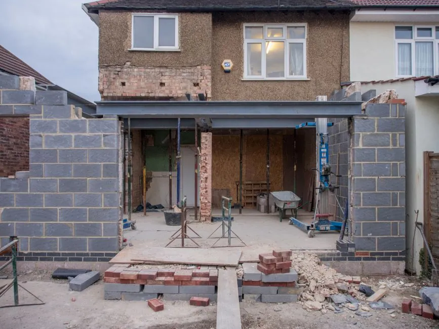 Single-storey rear extension with a flat roof seen from a garden