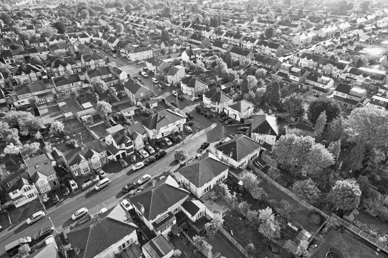 Aerial view of a British suburban area showing semi-detached houses and bungalows with varied roof pitches