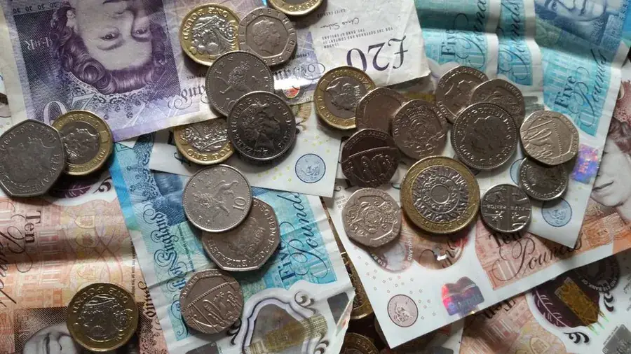 British pound coins and banknotes spread out, representing the cost of stone slate roof work