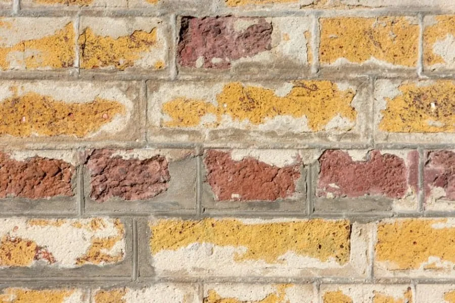 Damaged mortar and flashing around a brick chimney stack