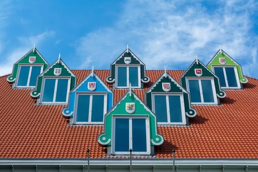 A complex period roofline with several valleys between gables and dormers