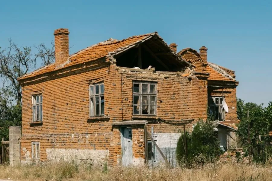 A weathered chimney stack with crumbling mortar and loose pointing