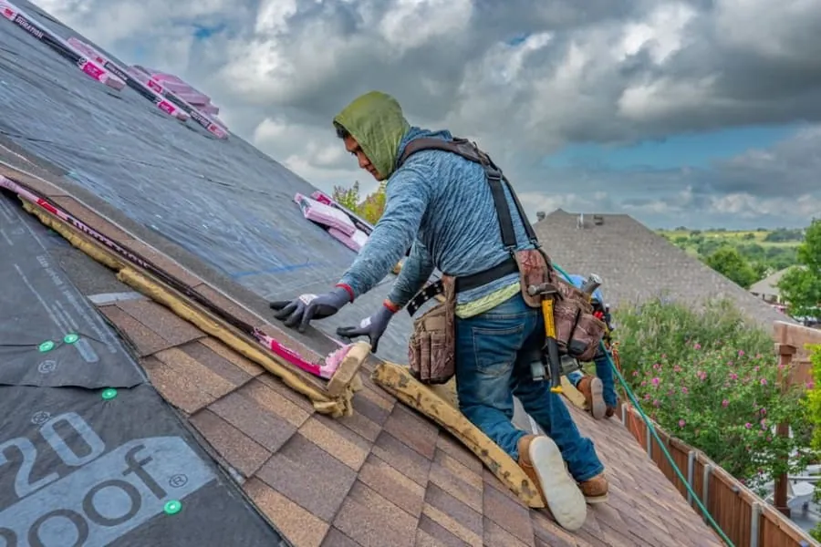 Insulation being laid on a flat roof deck during construction