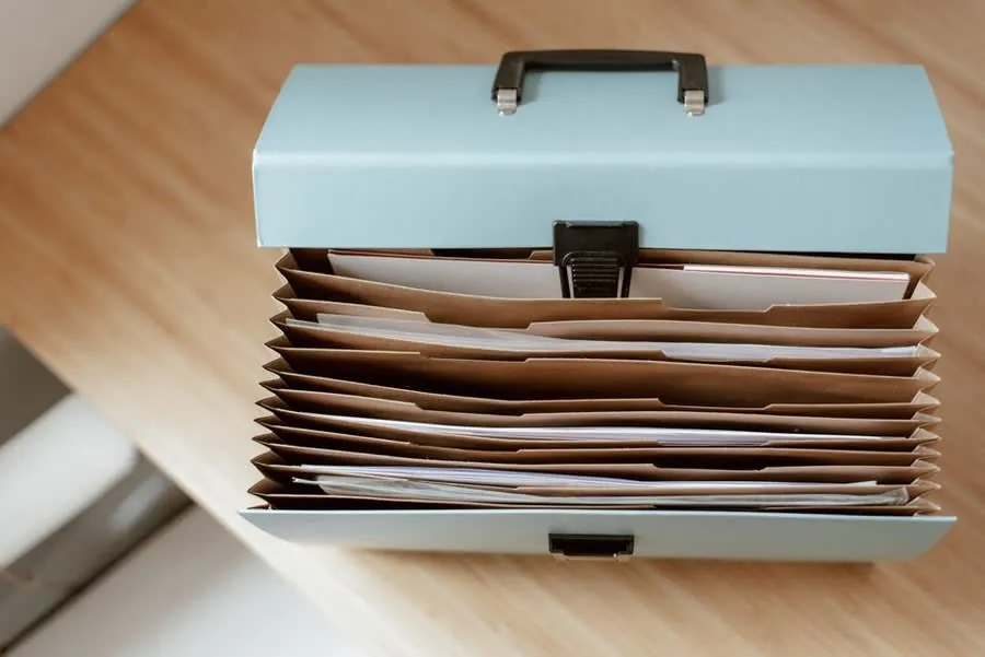 Insurance policy documents and folders on a desk