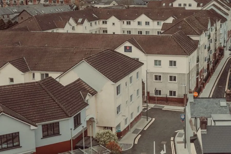 Aerial view of a dense residential development with pitched roofs and shared roof structures