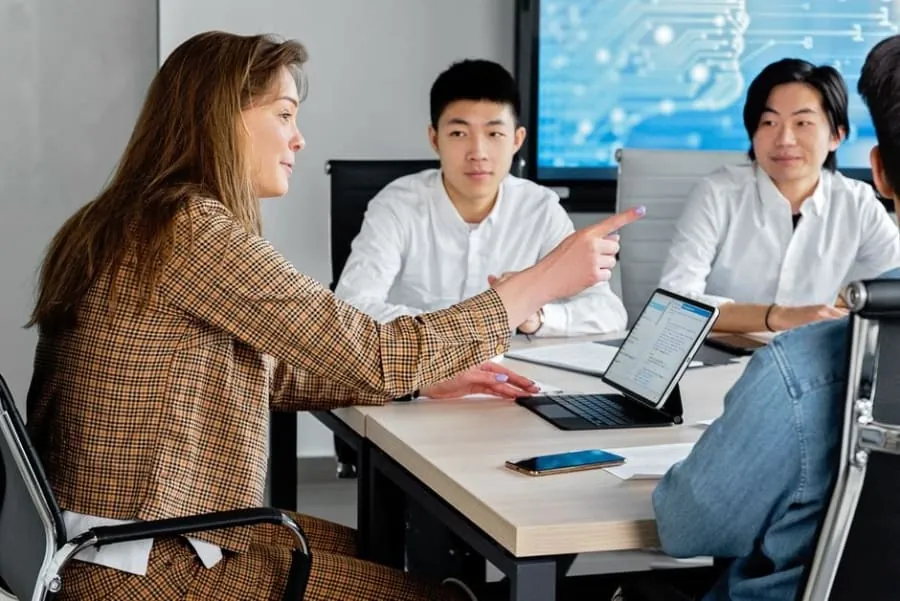 Small group of people in a meeting discussing building management decisions