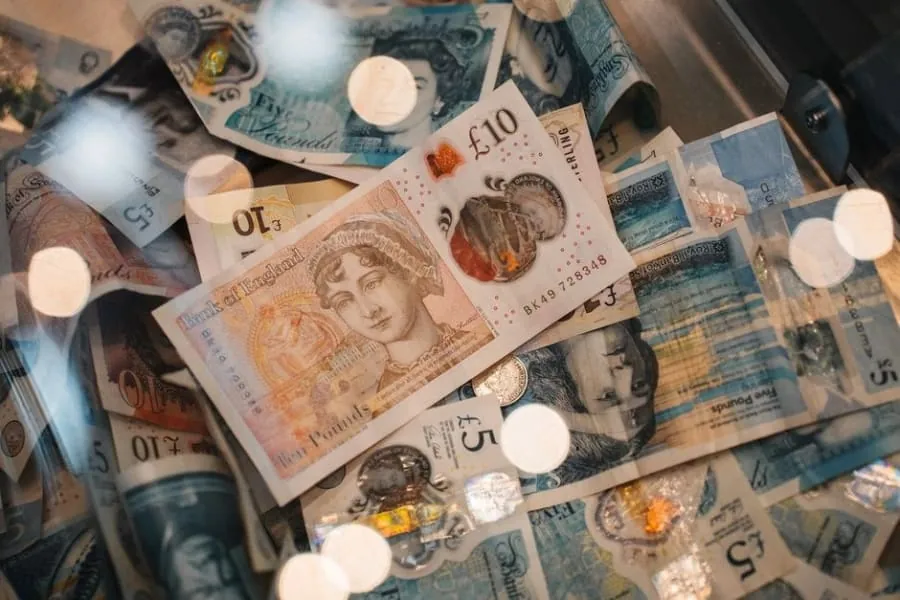British pound notes and coins representing a cash payment for roofing work
