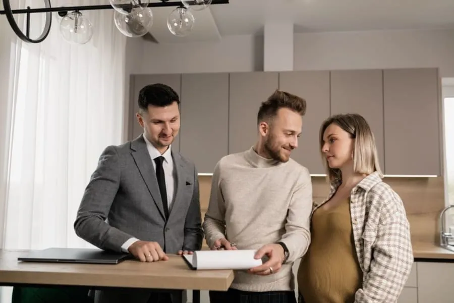 Couple reviewing a contractor agreement at their kitchen table before signing