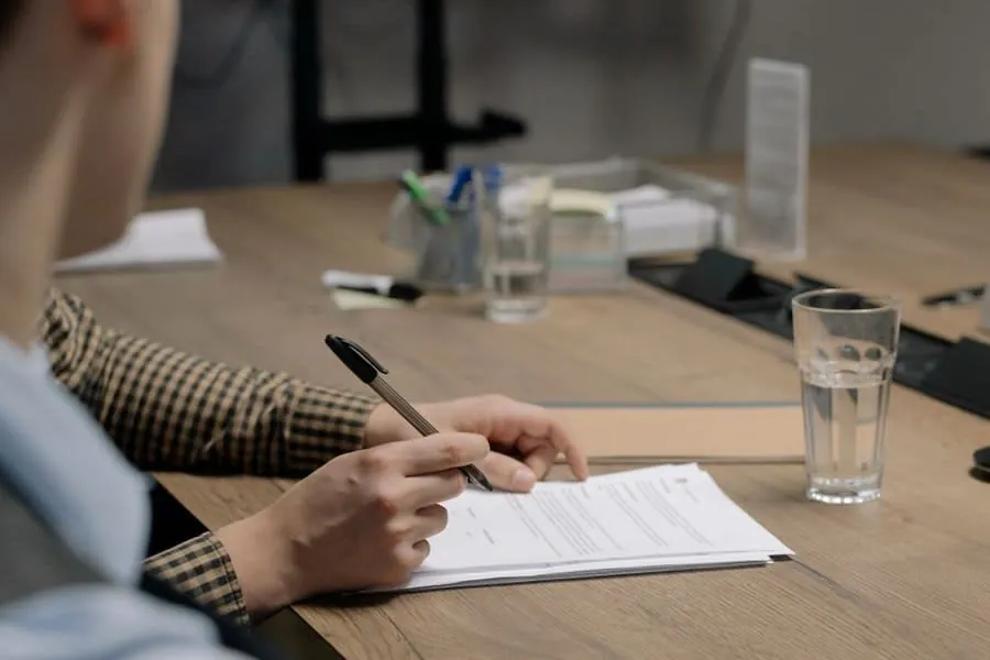 Roofing contract paperwork and pen on a table before signing