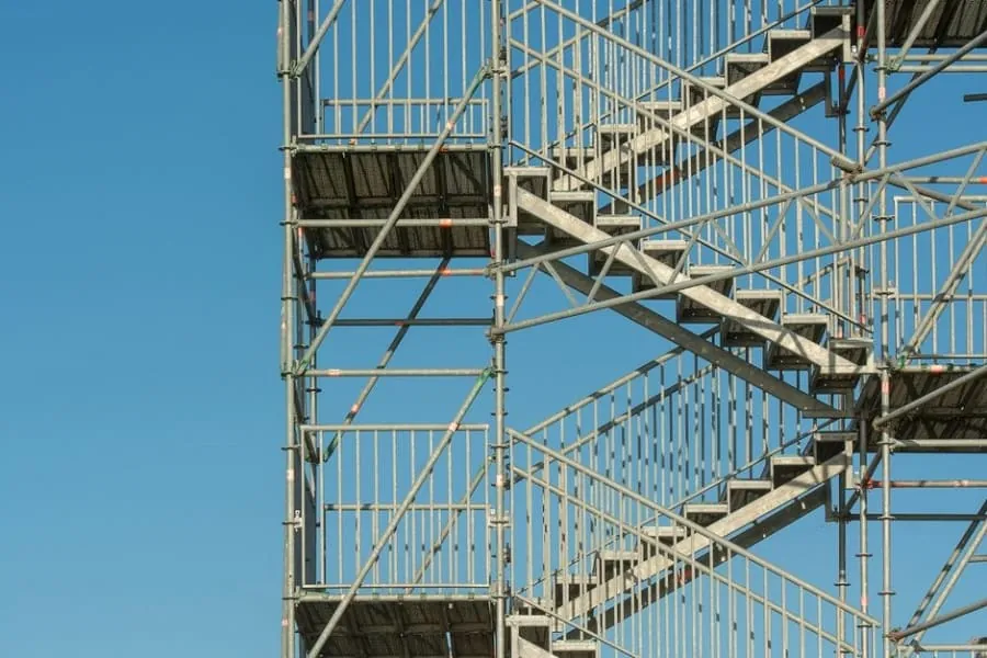 Scaffolding erected around a house in preparation for roof replacement work