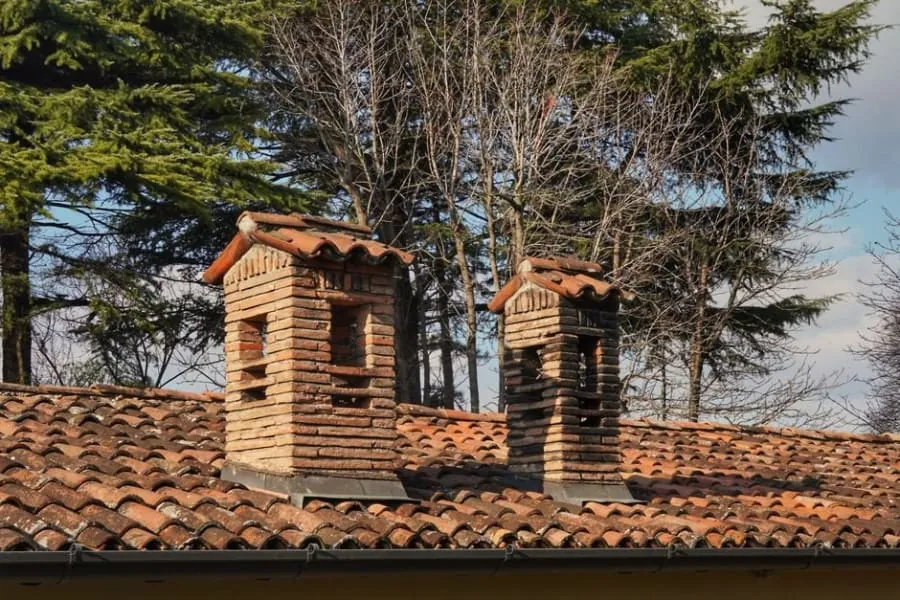 Stepped lead flashing running up the side of a brick chimney