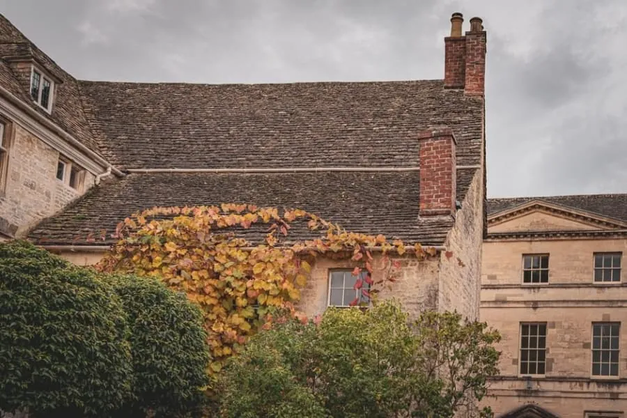 The stone roof and chimney stacks of an old listed building in England