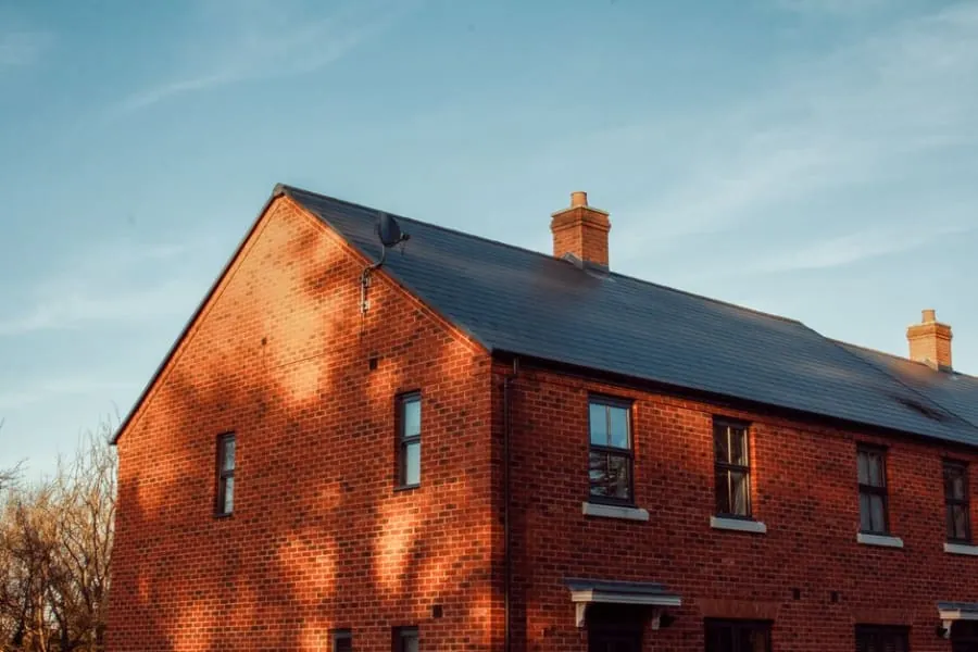 A brick English home with a well-matched tiled roof