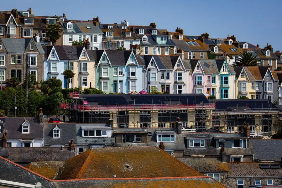 A tall Victorian terraced house wrapped in scaffolding