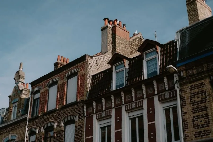 A shared chimney stack straddling the party wall between two terraced houses