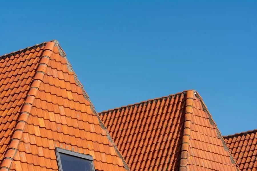 New roof tiles being laid on fresh battens and membrane