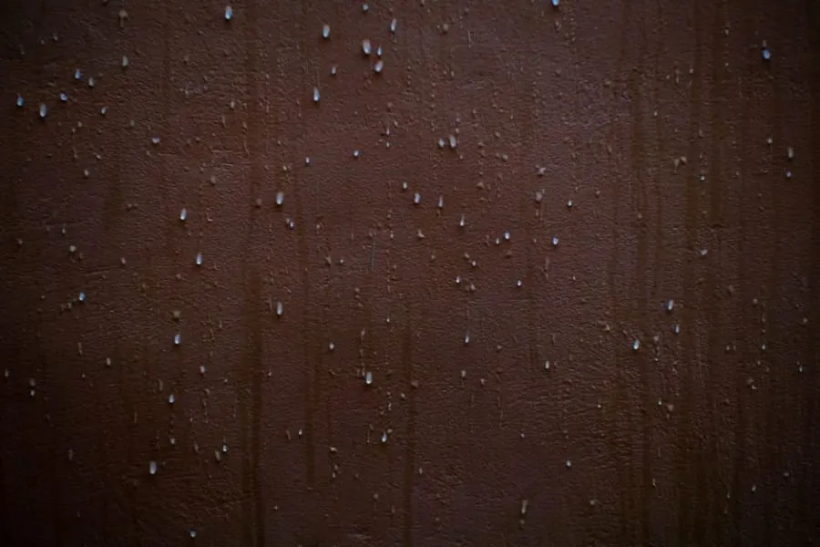 A ceiling stain part-way in from the wall, the signature of a valley leak